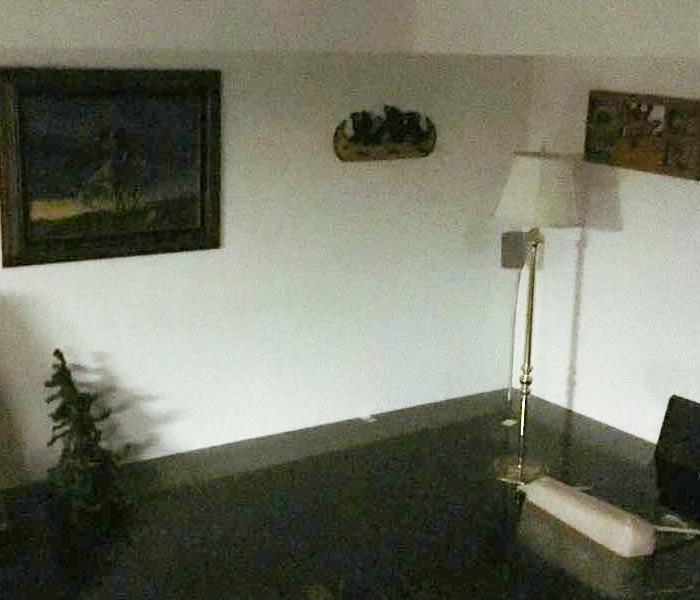 Living room with a lamp and 16 inches of water