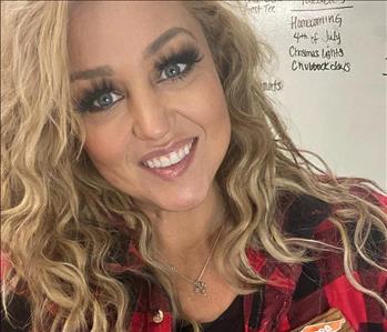 Woman in red plaid with blonde hair