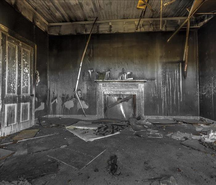 Room covered in soot with a fireplace